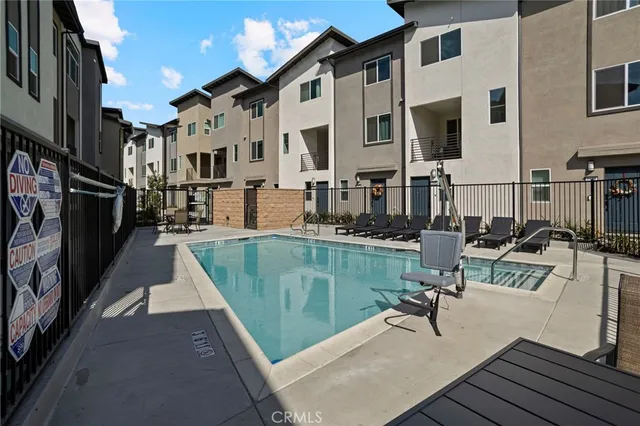 a view of a patio with couches chairs and wooden floor