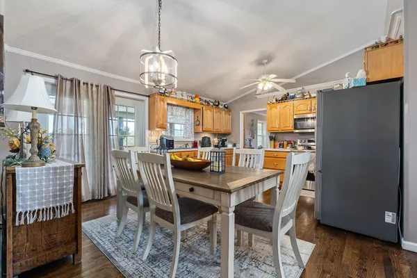 a kitchen with stainless steel appliances a stove a sink dishwasher a refrigerator and a oven with wooden floor