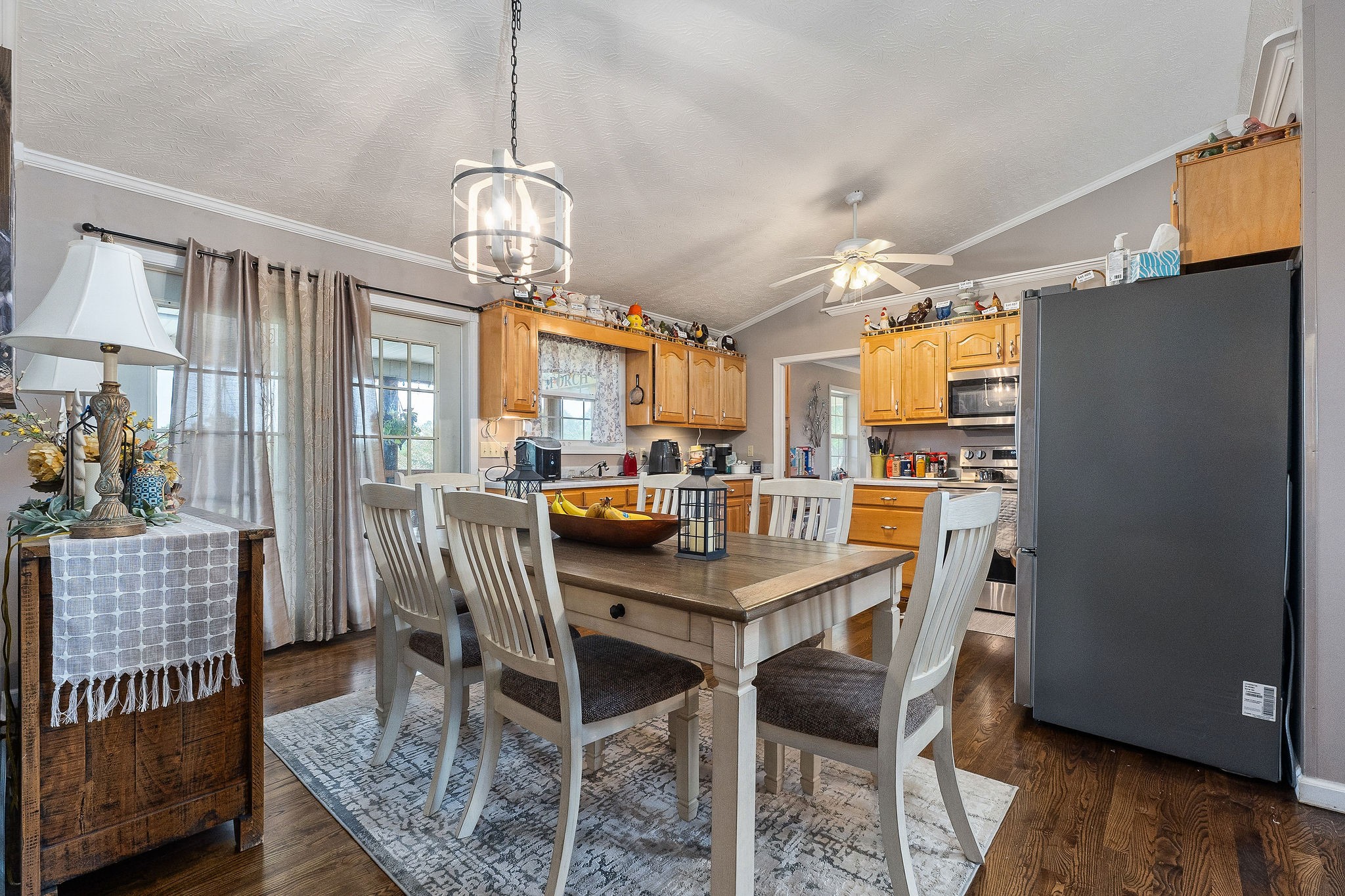 126 Ozone Road Monroe, TN 38573 - Photo 19 of 40 a dining room with furniture a chandelier and wooden floor