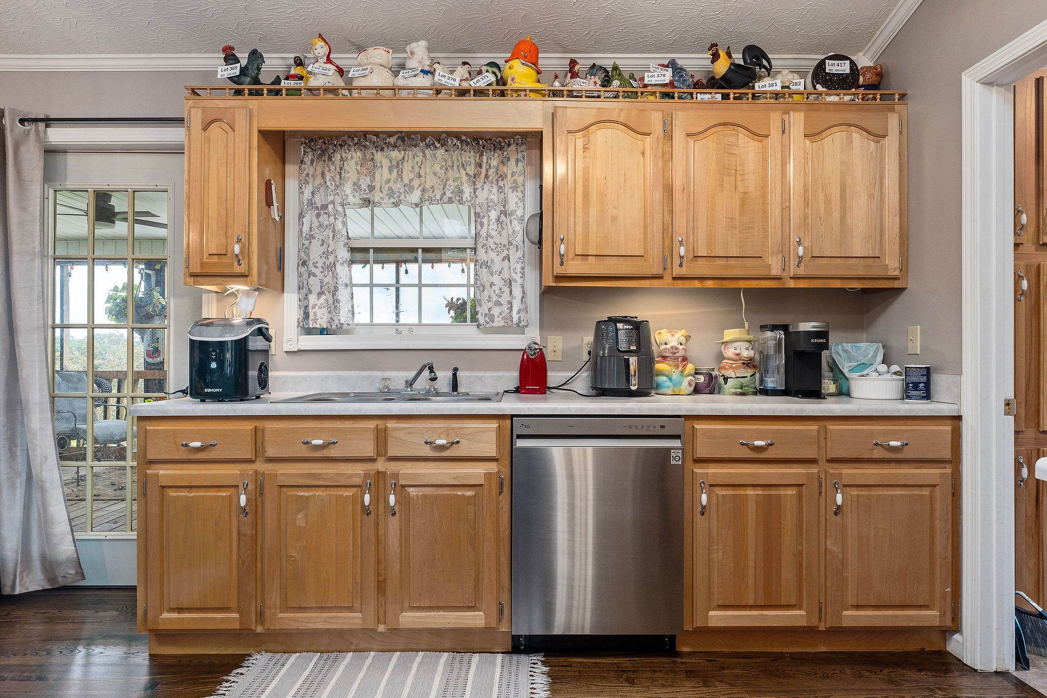 126 Ozone Road Monroe, TN 38573 - Photo 21 of 40 a kitchen with granite countertop a sink cabinets and wooden floor