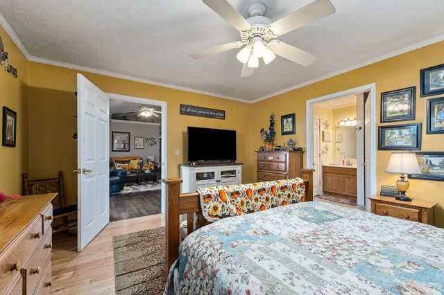 a bedroom with furniture and a flat screen tv