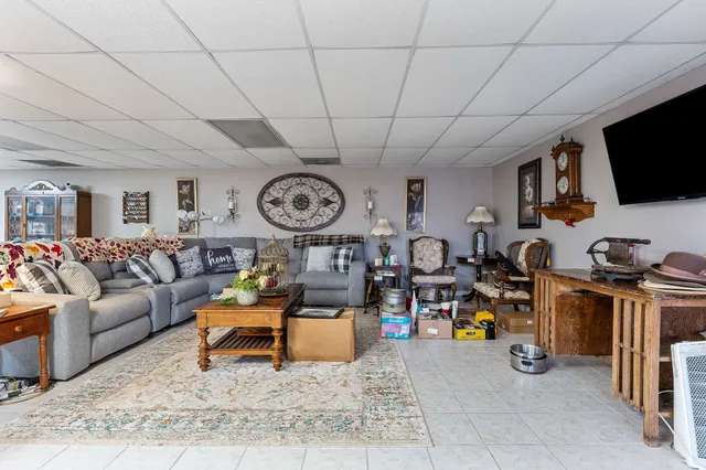 a view of a livingroom with workspace and a window