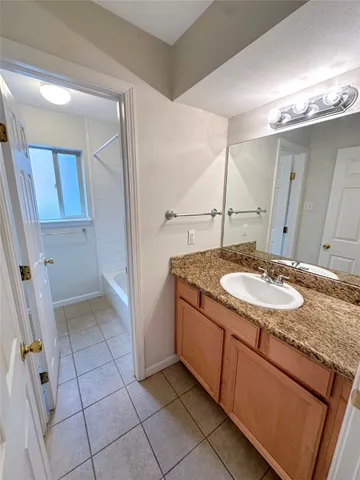 a kitchen with kitchen island granite countertop a sink and a stove top oven