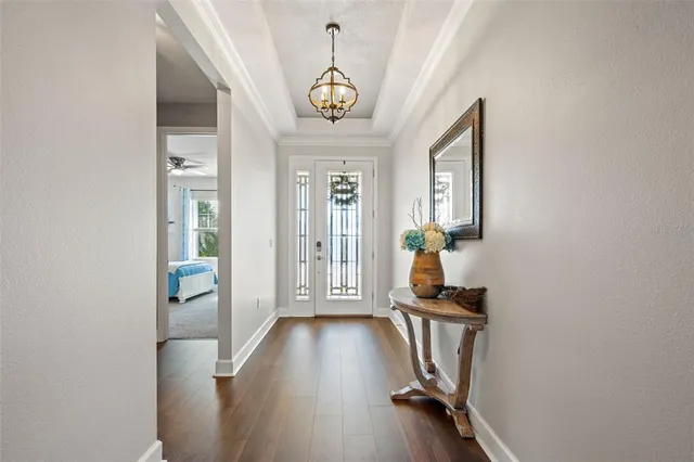 a view of a hallway with wooden floor and entryway