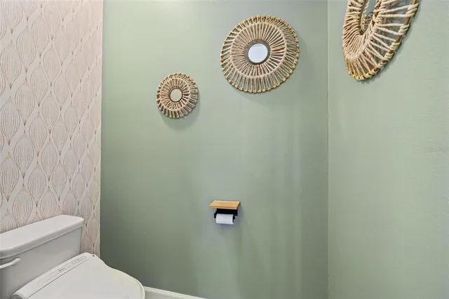 a bathroom with a granite countertop sink toilet mirror and shower