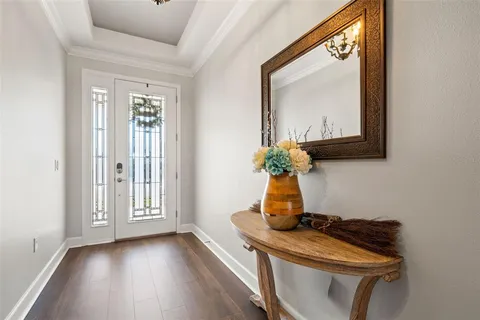 a kitchen with kitchen island granite countertop a sink cabinets and wooden floor