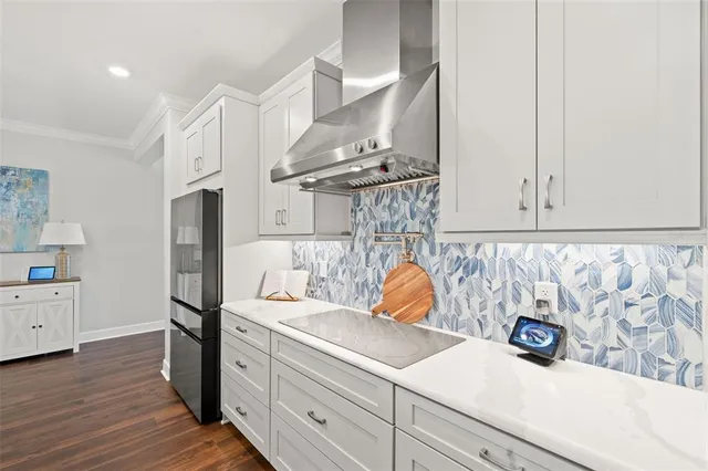 a kitchen with stainless steel appliances kitchen island granite countertop a table chairs and a view of living room