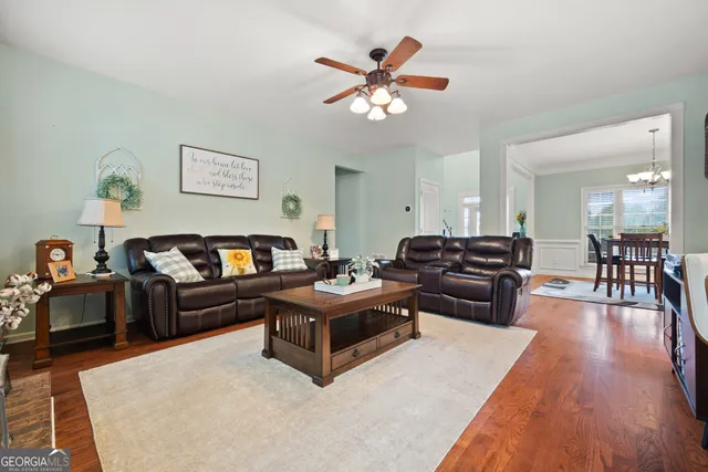 a living room with furniture and a chandelier