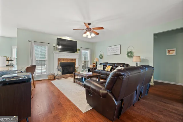 a living room with furniture a flat screen tv and a fireplace