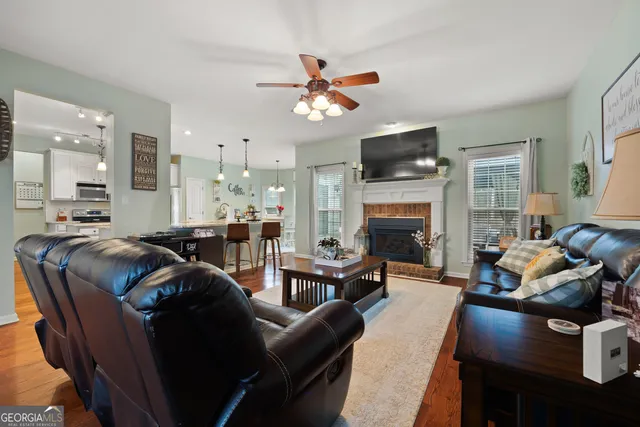 a living room with furniture a flat screen tv and a fireplace
