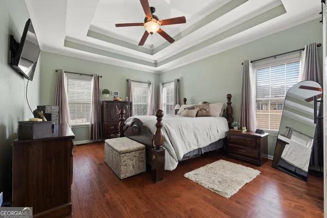 a bedroom with a bed a couch and a chandelier