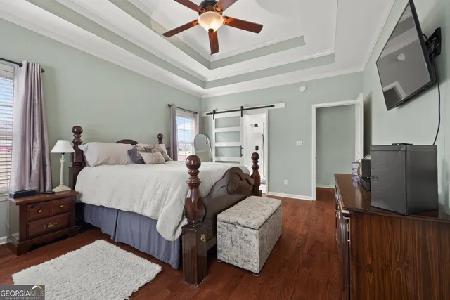 a bedroom with a bed window and dresser