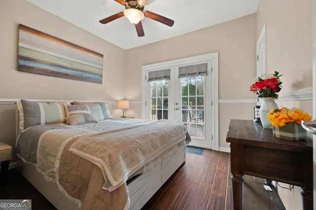 a bedroom with bed and wooden floor