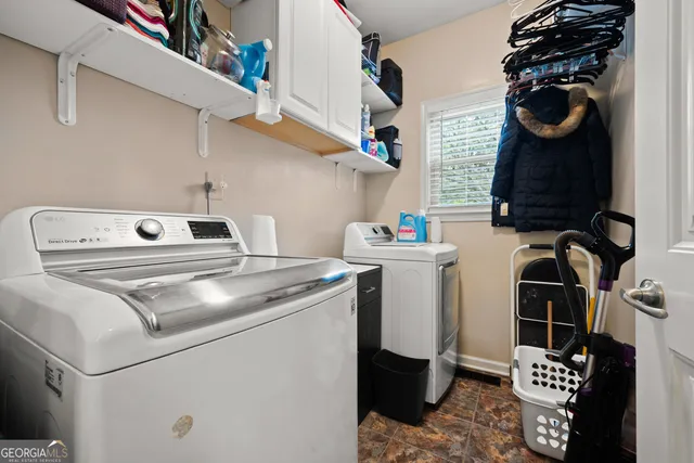 a utility room with dryer washer and other items