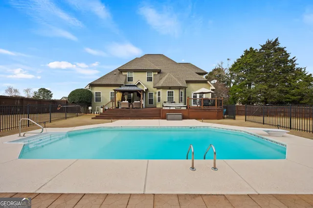 a patio with a table and chairs under an umbrella