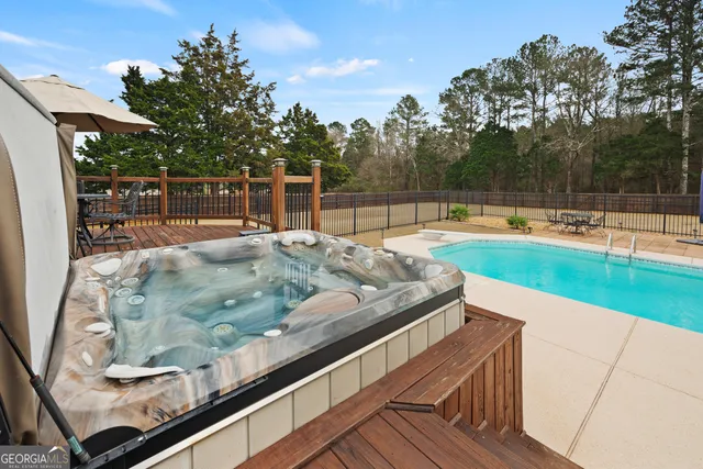 a view of a backyard with swimming pool
