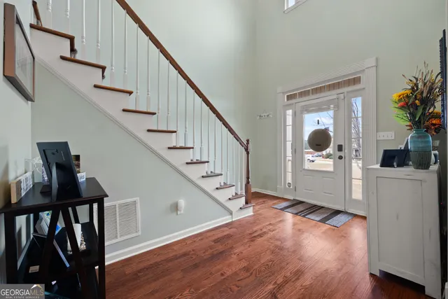 a view of entryway with wooden floor and stairs