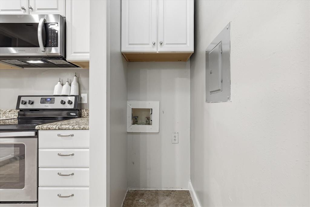 14277 Preston Road, Unit 615 Dallas, TX 75254 - Photo 12 of 20 a kitchen with a refrigerator and cabinets