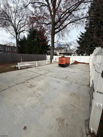 a parking space covered with tall trees