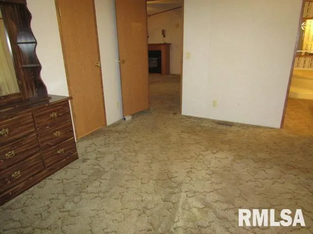 a view of an empty room and wooden floor