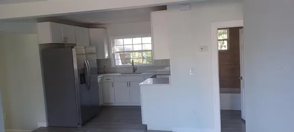 a kitchen with refrigerator and window