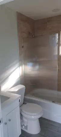 a bathroom with a toilet and a shower