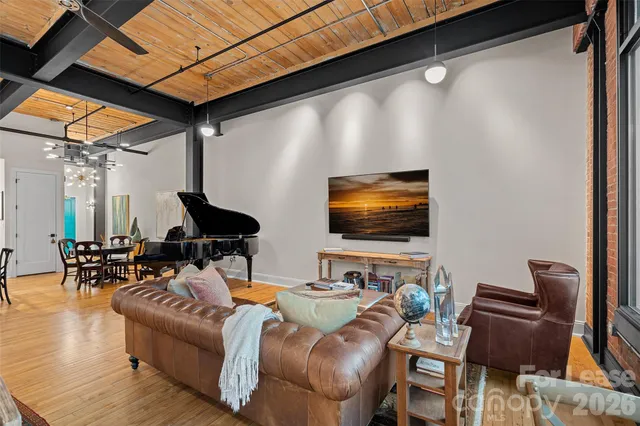a living room with furniture a table and chairs