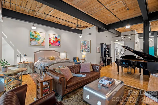 a living room with furniture and a floor to ceiling window
