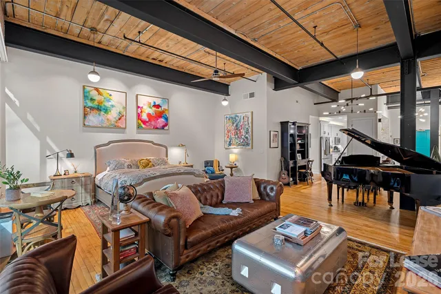 a living room with furniture and a floor to ceiling window