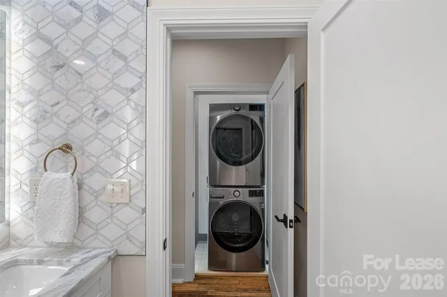a bathroom with a granite countertop sink a mirror and a shower