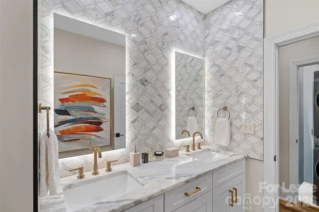a bathroom with a double vanity sink and a mirror
