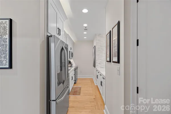 a bathroom with double vanity and mirrors