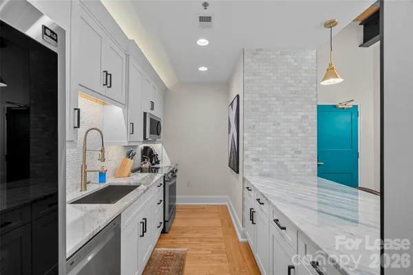 a large kitchen with granite countertop a lot of counter top space