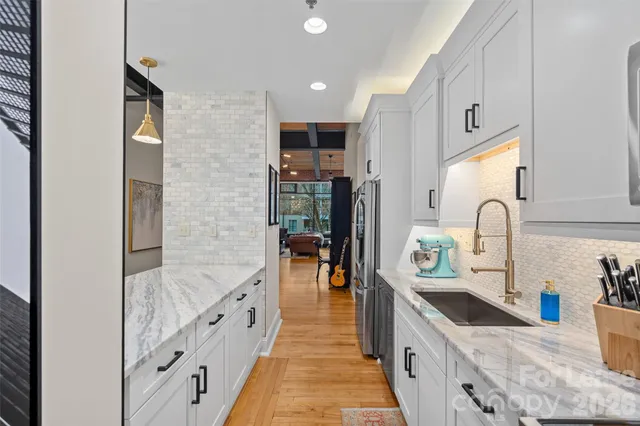 a view of a hallway with front door and wooden floor