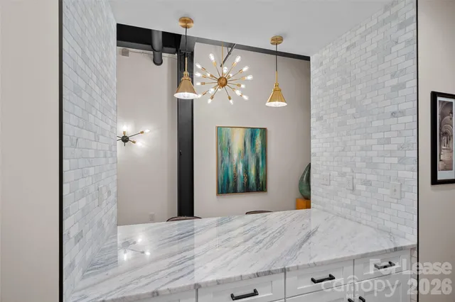 a dining room with wooden floor a table and chairs