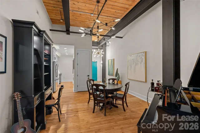 a living room with furniture a flat screen tv and a floor to ceiling window