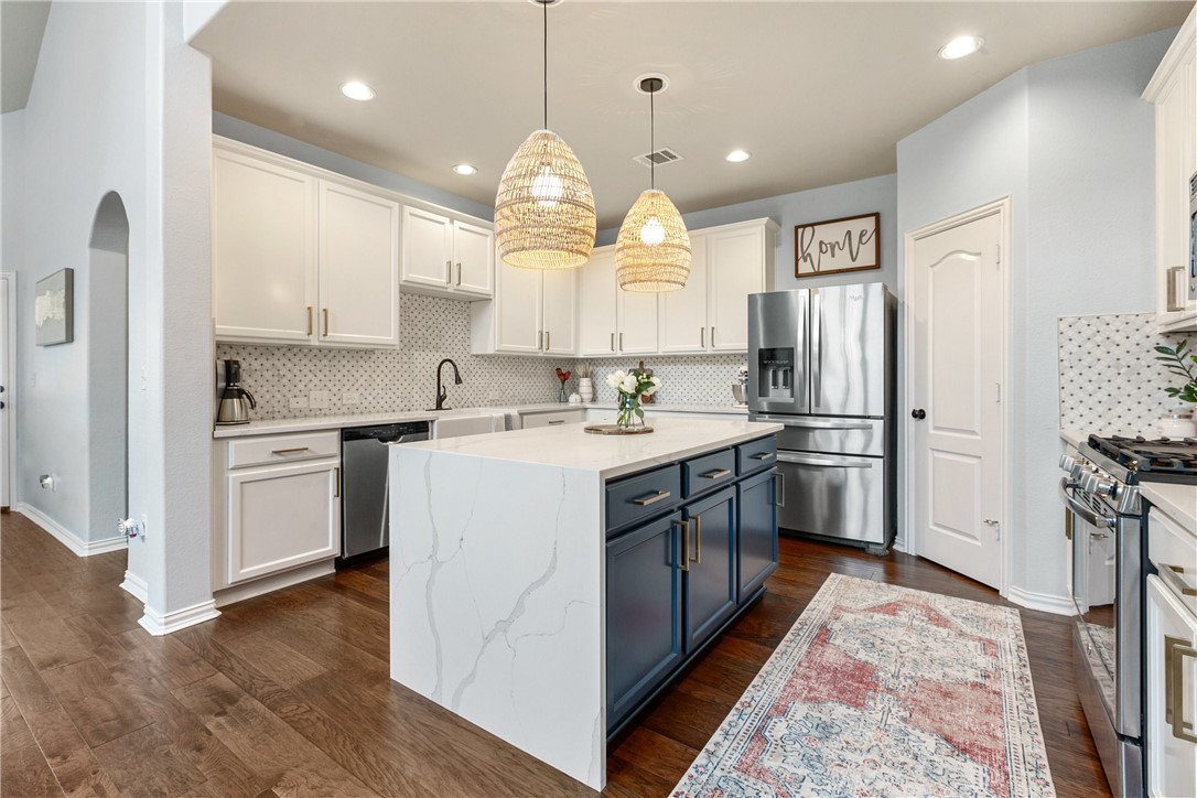 a kitchen with a sink window and refrigerator