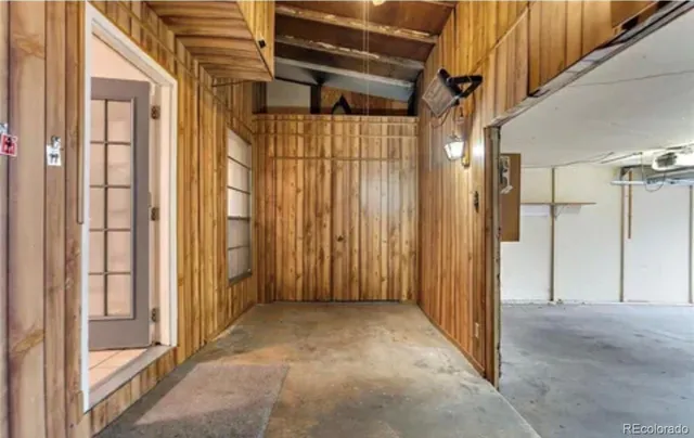 a view of a hallway with wooden walls
