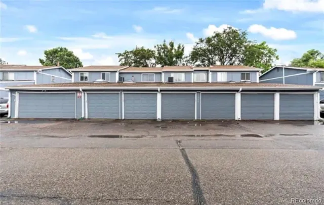 a house with a large window and brick wall