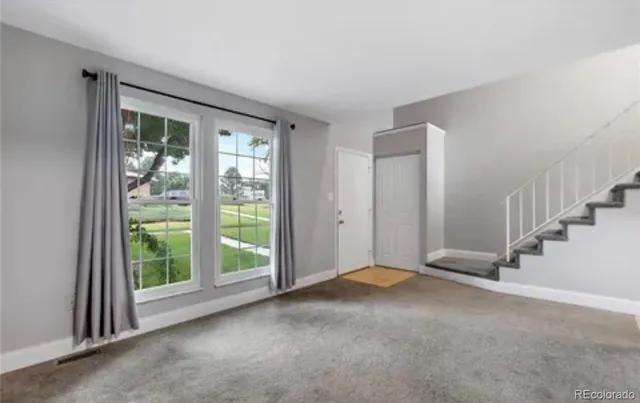 a view of an empty room with windows