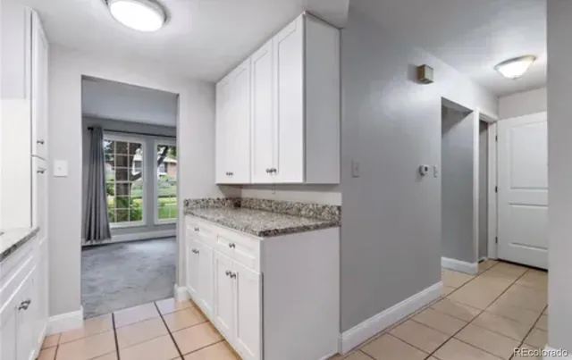 a bathroom with a granite countertop sink a toilet and a shower