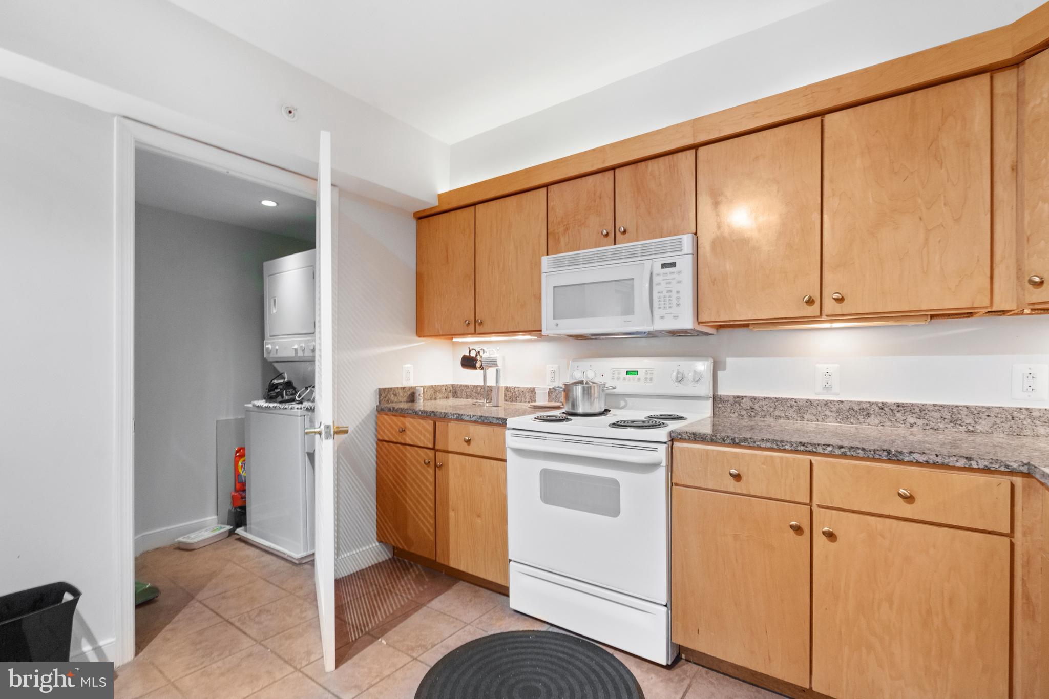 616 E Street Northwest, Unit 304 Washington, DC 20004 - Photo 23 of 53 a kitchen with stainless steel appliances granite countertop a sink stove and cabinets