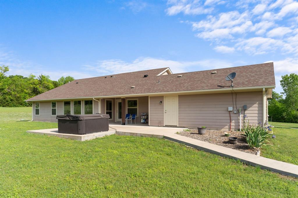 254 Jackson Road Whitewright, TX 75491 - Photo 14 of 40 Back yard view of jacuzzi and large patio