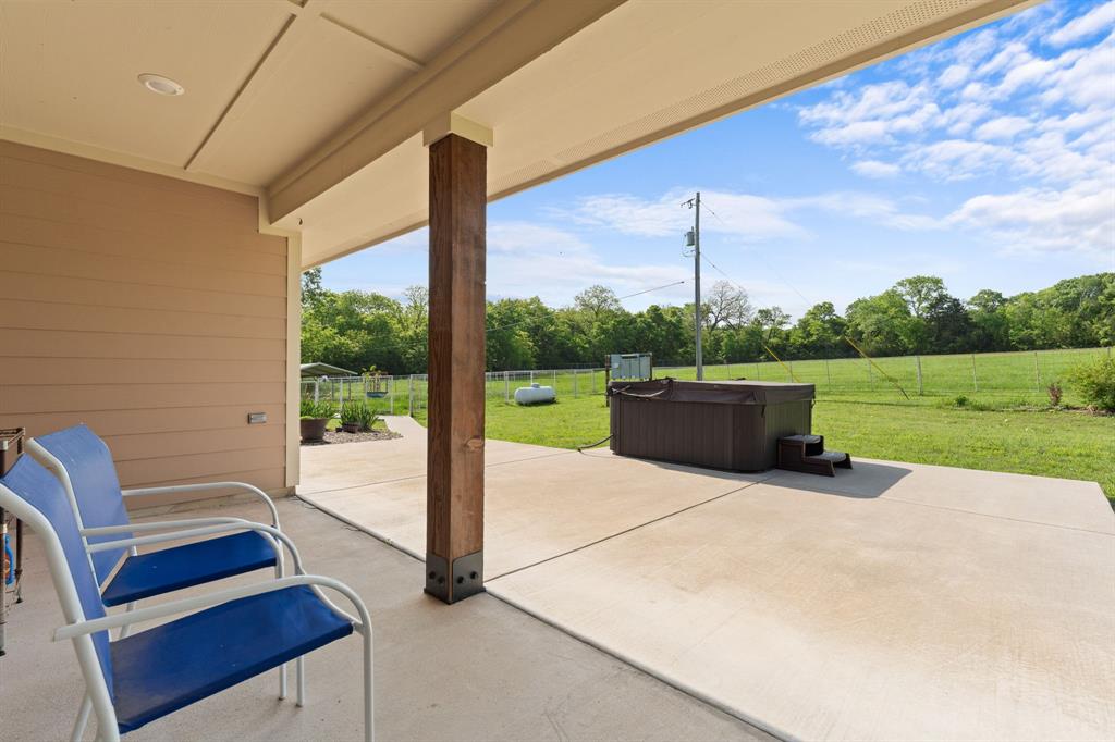 254 Jackson Road Whitewright, TX 75491 - Photo 15 of 40 Covered patio view of jacuzzi and pasture