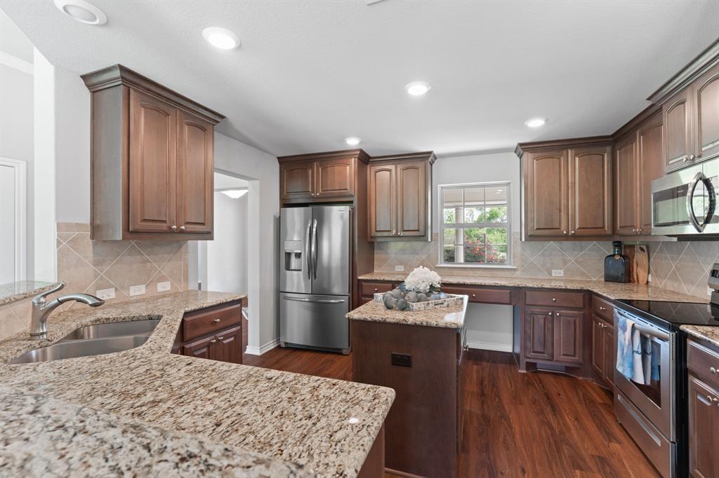 254 Jackson Road Whitewright, TX 75491 - Photo 22 of 40 Kitchen - with work desk and view of driveway and porch