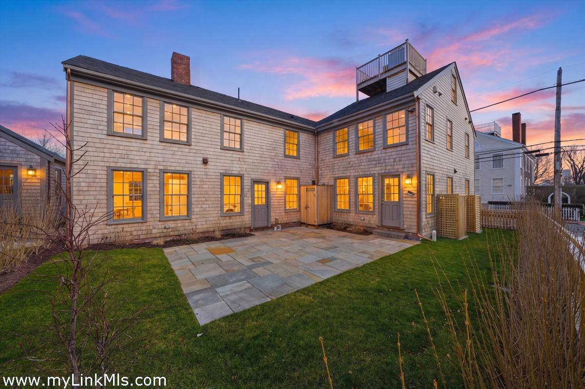 85 Orange Street Nantucket, MA 02554 - Photo 3 of 89 a front view of a house with a yard