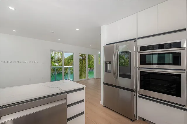 a kitchen with stainless steel appliances a stove and microwave