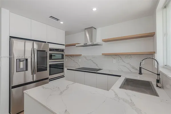a kitchen with stainless steel appliances a refrigerator and a sink