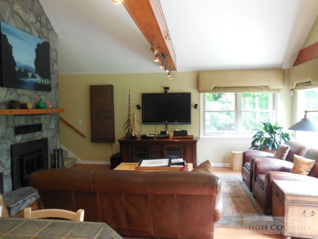 378 Howard's Creek Road Boone, NC 28607 - Photo 3 of 35 a living room with furniture and a flat screen tv