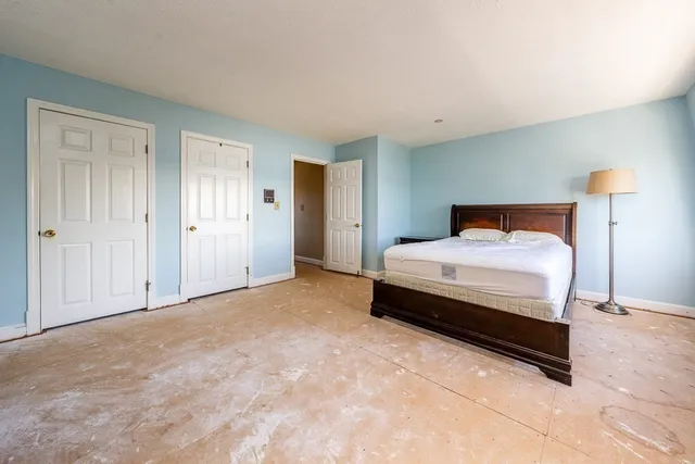 a bedroom with a bed and a lamp